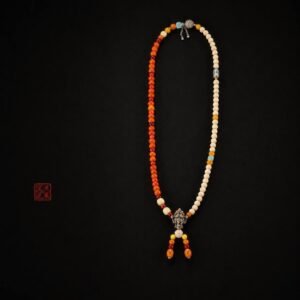 Full-length Tingdi 108-bead necklace on a dark background