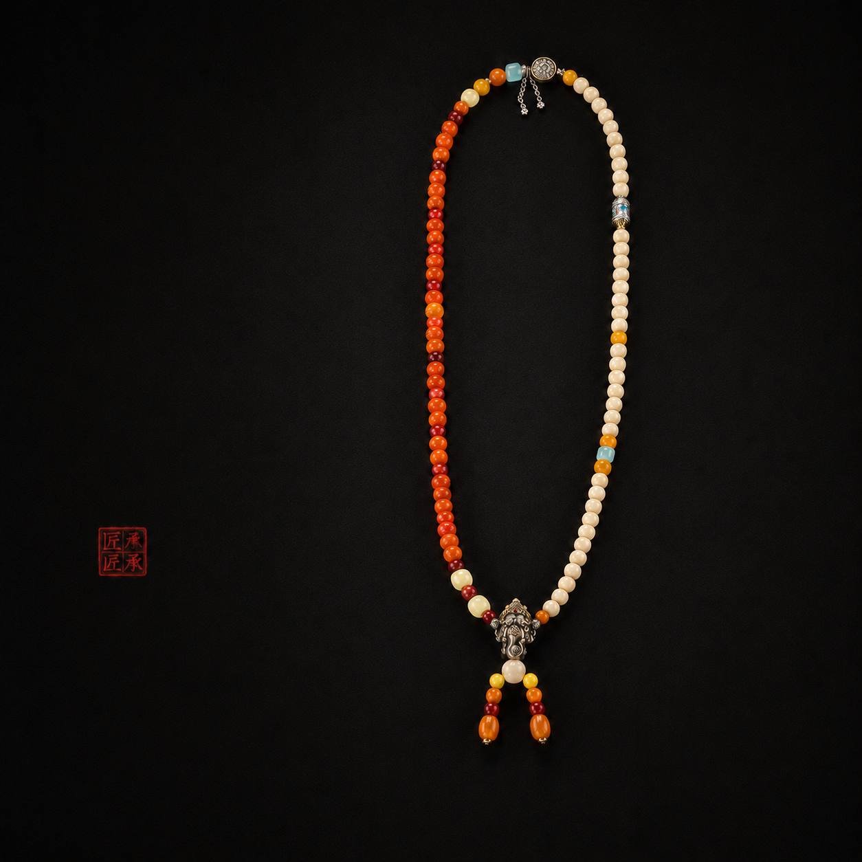 Full-length Tingdi 108-bead necklace on a dark background