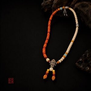Tingdi bead necklace displayed with dark carved wood accents