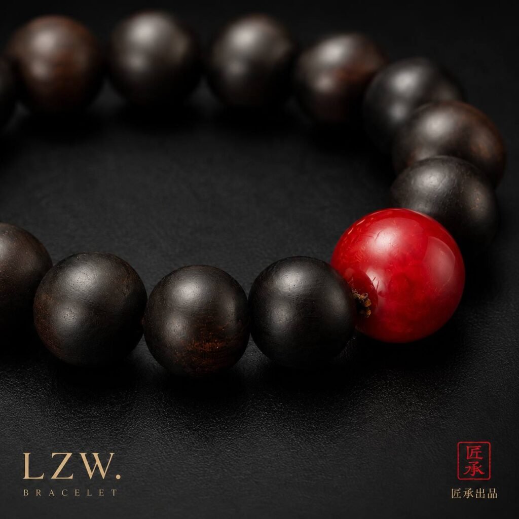 Close-up of black-toned wood beads and vivid red focal bead on Iron and Crimson bracelet