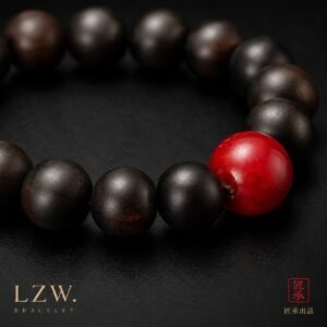 Close-up of black-toned wood beads and vivid red focal bead on Iron and Crimson bracelet