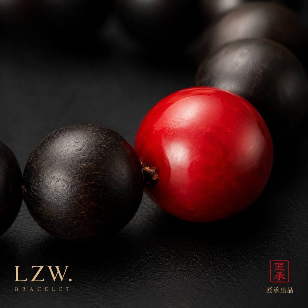 Detail of vivid red focal bead and dark wooden beads on Iron and Crimson bracelet