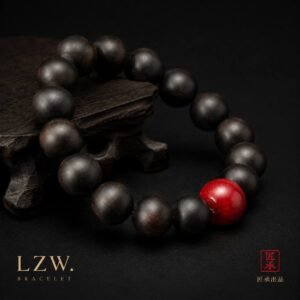 Iron and Crimson black-toned wood bead bracelet beside a carved wooden stand
