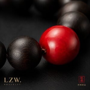 Detail of vivid red focal bead and dark wooden beads on Iron and Crimson bracelet