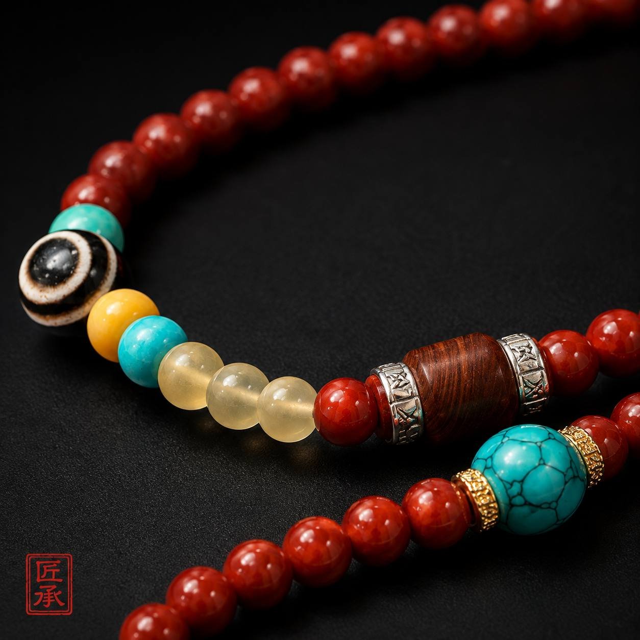 Detail of Dzi bead and mixed accent beads on Angel's Eye Nanhong agate mala