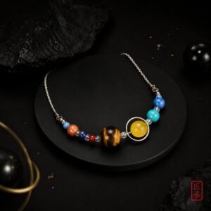 STELLAR ORBIT multi-bead necklace arranged on a black display pedestal