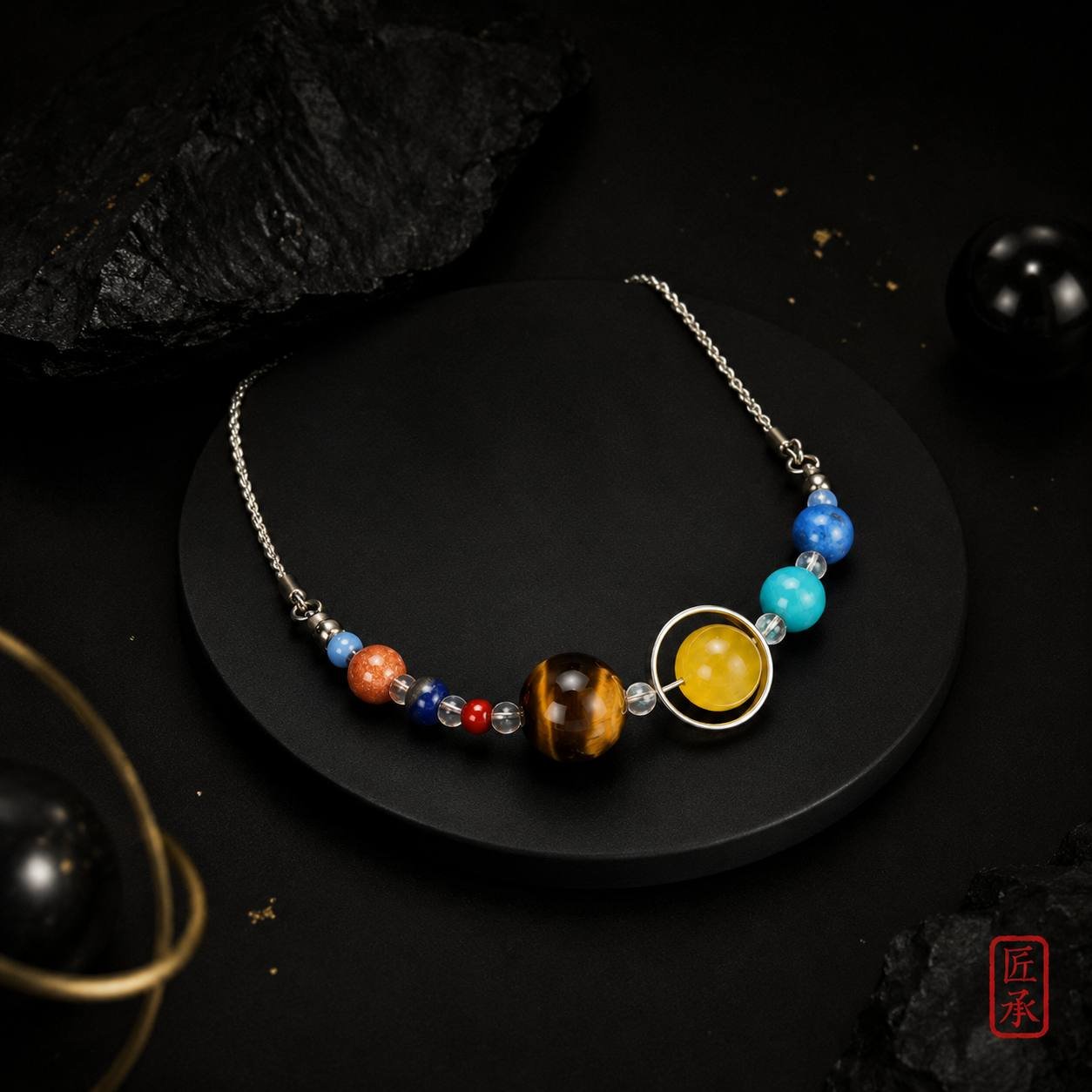 STELLAR ORBIT multi-bead necklace arranged on a black display pedestal