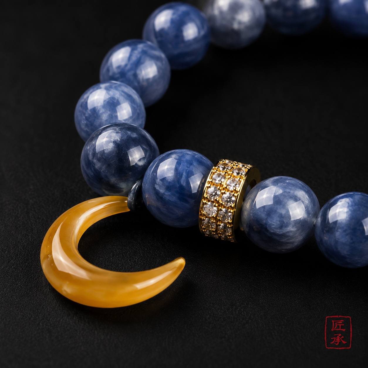 Close-up of MOONFALL BLUE blue beads, gold-tone spacer, and yellow crescent accent