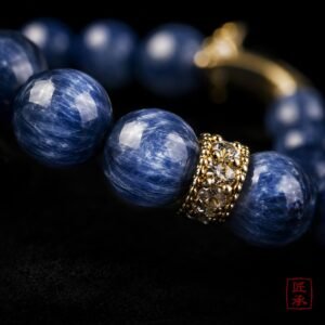 Macro view of blue striated beads and gold-tone spacer on MOONFALL BLUE bracelet