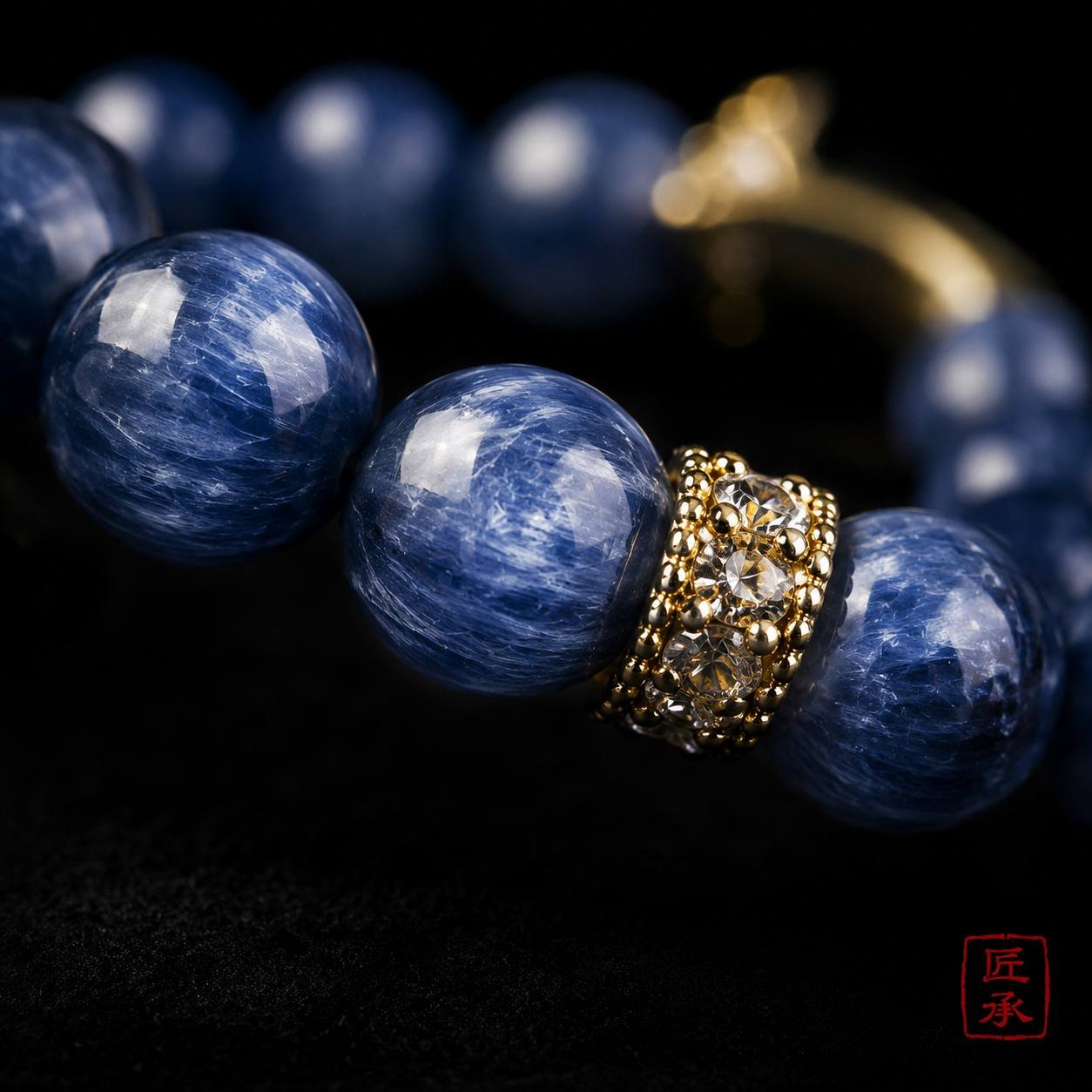 Macro view of blue striated beads and gold-tone spacer on MOONFALL BLUE bracelet