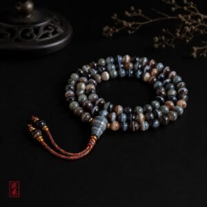 SHADOWED TIDES banded agate 108-bead mala displayed on a dark surface