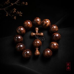 EMBER FLOW Huanghuali wood bead bracelet arranged on a dark surface