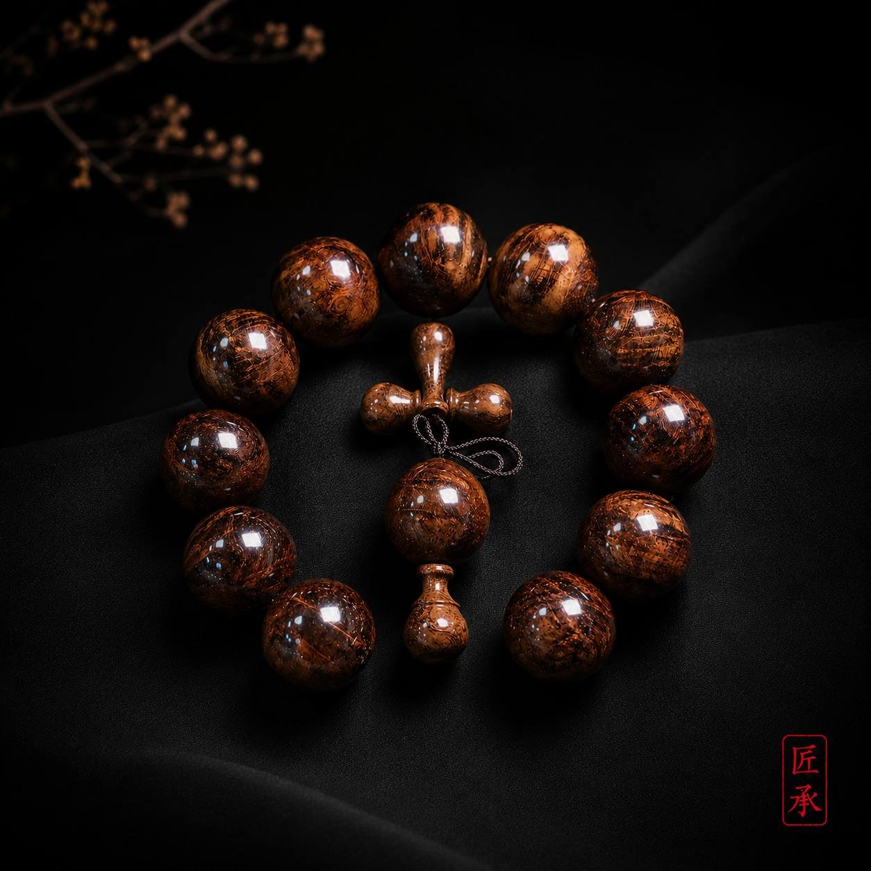EMBER FLOW Huanghuali wood bead bracelet arranged on a dark surface