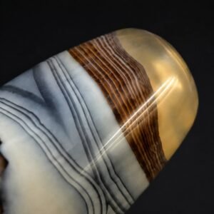 Close-up of CLOUD VEIL agate barrel bead showing warm brown and translucent end detail