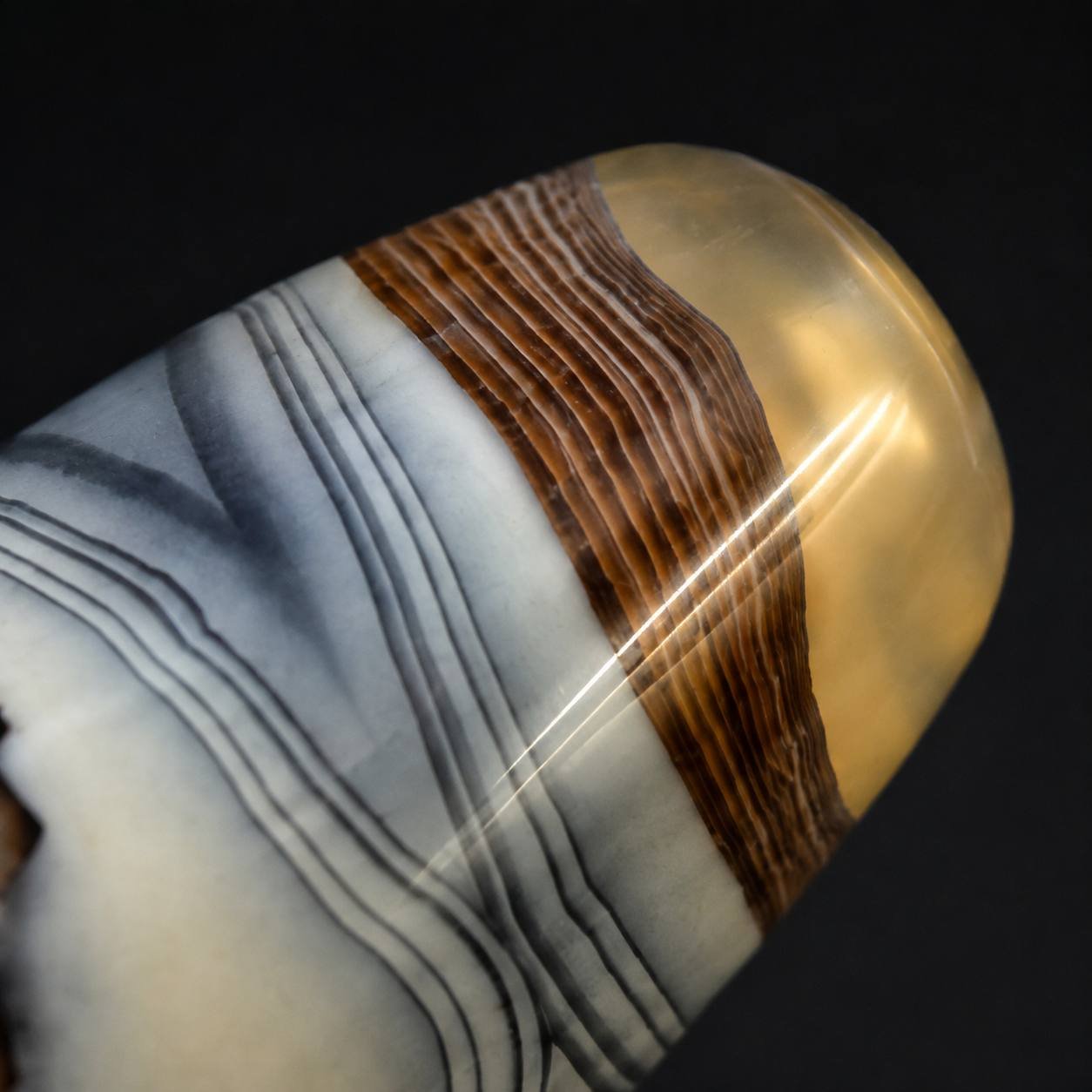 Close-up of CLOUD VEIL agate barrel bead showing warm brown and translucent end detail