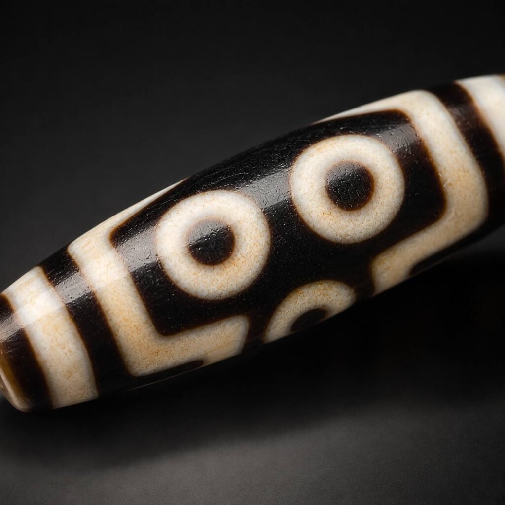 Macro view of TWIN GAZE two-eye motif on a Dzi bead