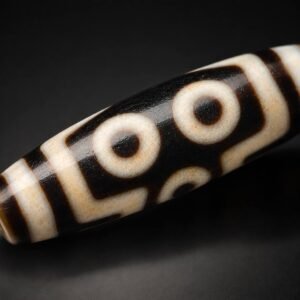 Macro view of TWIN GAZE two-eye motif on a Dzi bead
