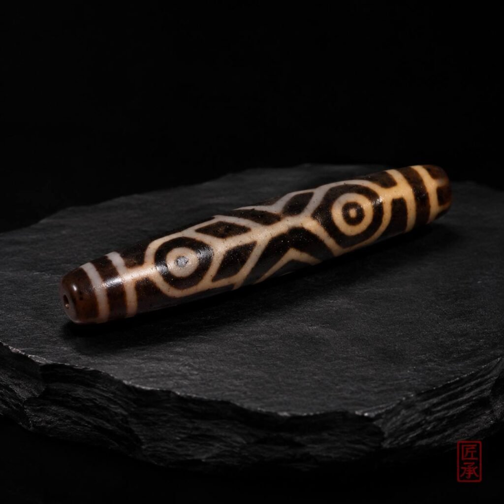 Tibetan Echo Bhutan Double Fish Dzi Bead on dark stone