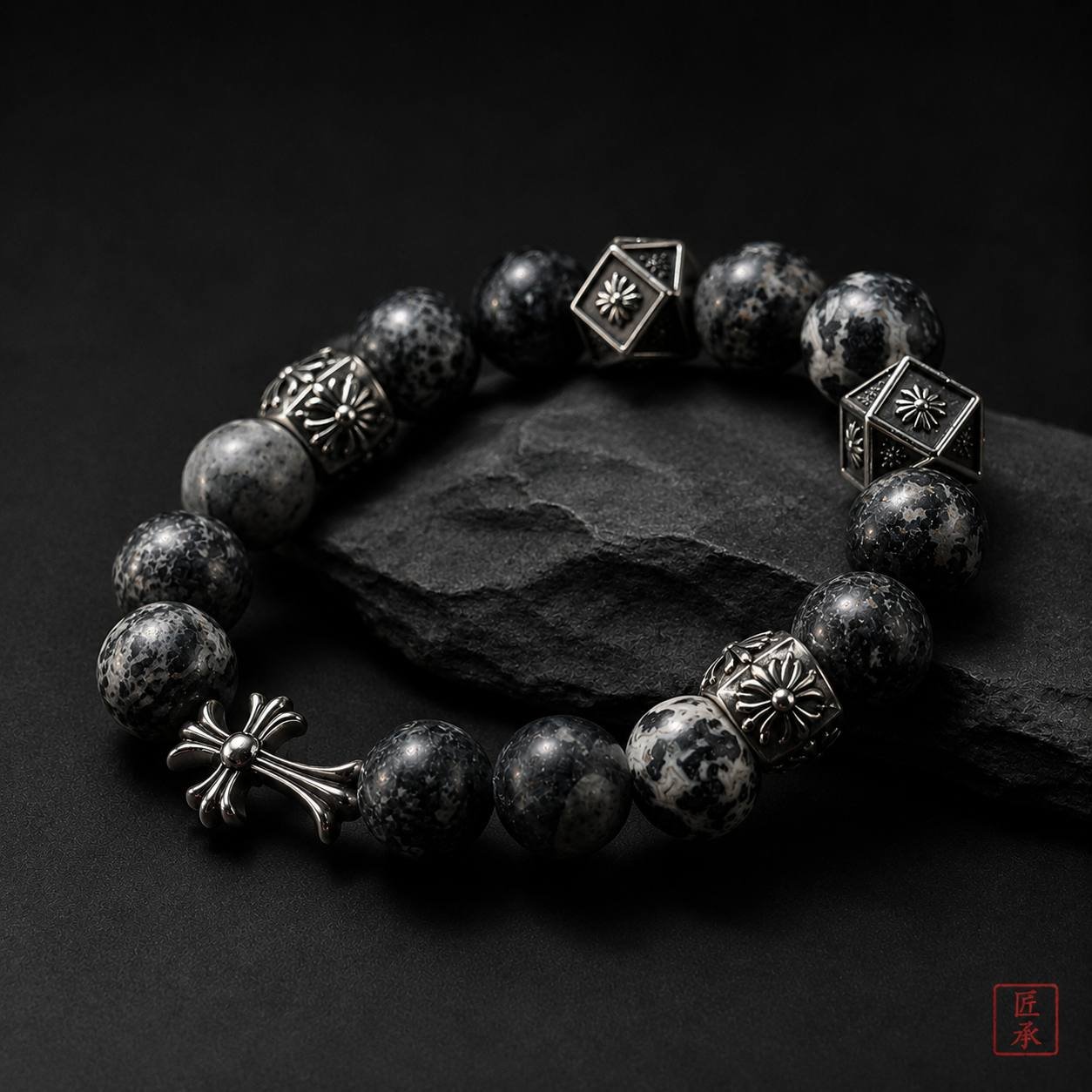 Black obsidian bead bracelet with decorative metal-toned components