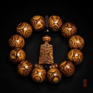 GILDED GRAIN Huanghuali bead bracelet with central pendant plaque, front view