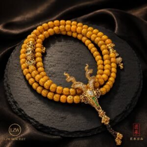 Close-up of amber-toned beads and ornate dragon pendant
