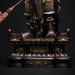 Guan Yu warrior statue with gilded armor on a traditional base