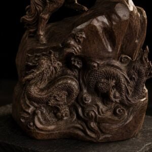Close-up of twin dragons and cloud motifs in dark wood