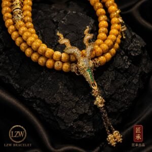 AMBER DRAGON mala necklace arranged on black slate