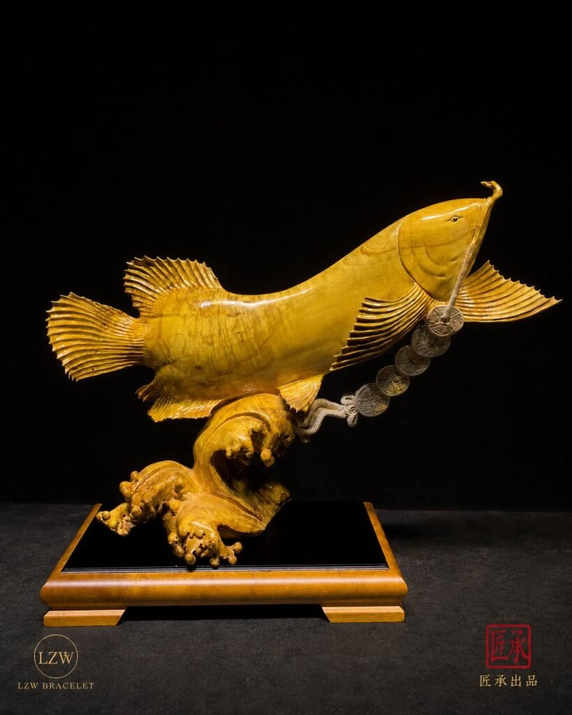 Golden Arowana sculpture with spread fins and natural wood grain